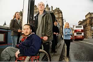 DDS Group member waits at a bus stop on Edinburgh's North Bridge