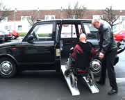 Still from the movie clip: Eleanor is half way up the ramps getting into a  Metrocab